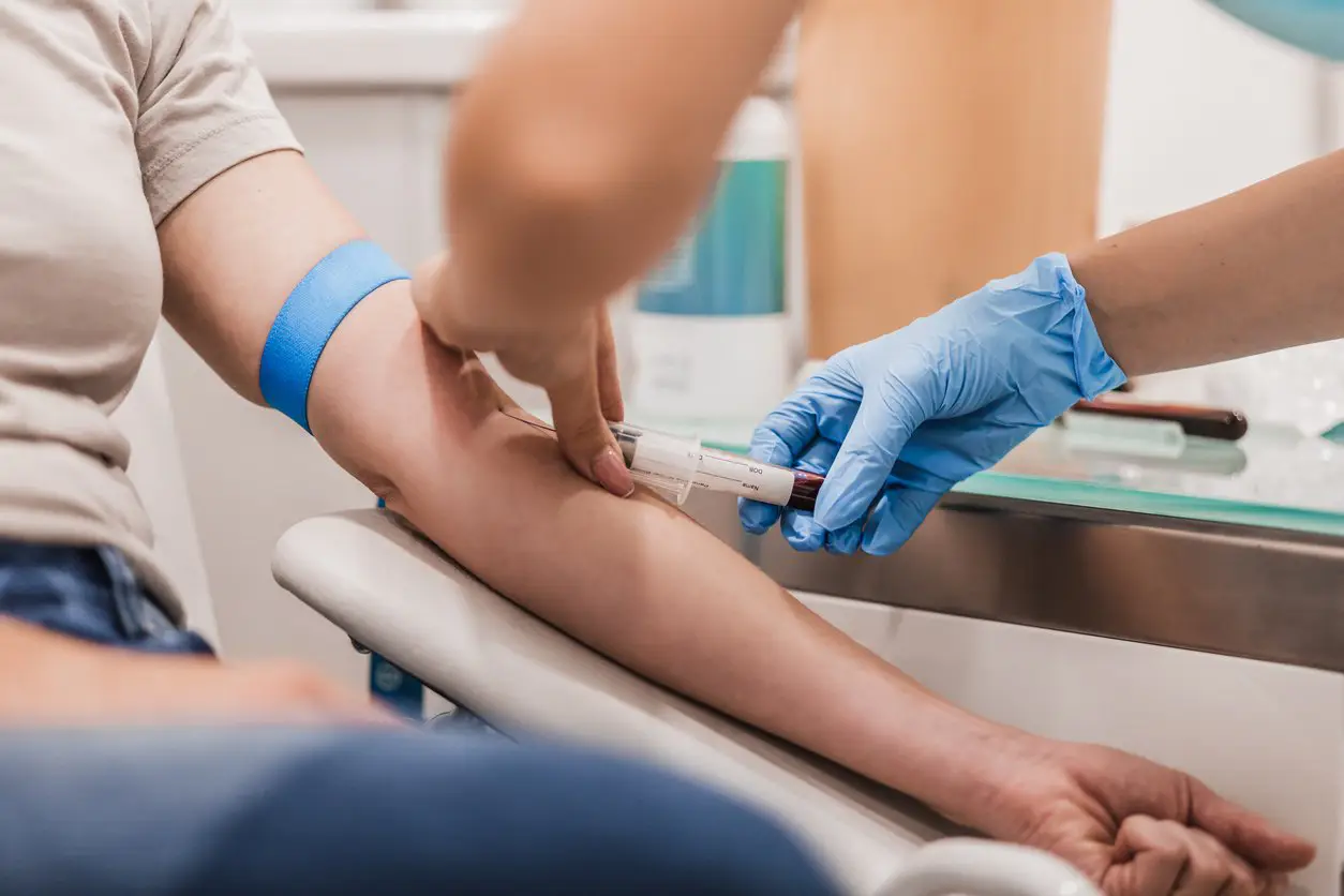 Blog 3 Close-up of a medical professional preparing a blood sample at Evolve HRT & Wellness in The Woodlands, TX, representing their lab work services.