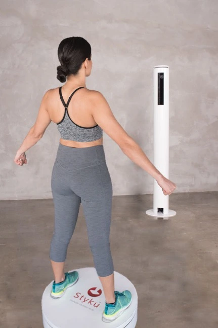 Portfolio 1 Woman standing on a digital scale, promoting body composition analysis at Evolve HRT & Wellness in The Woodlands, TX