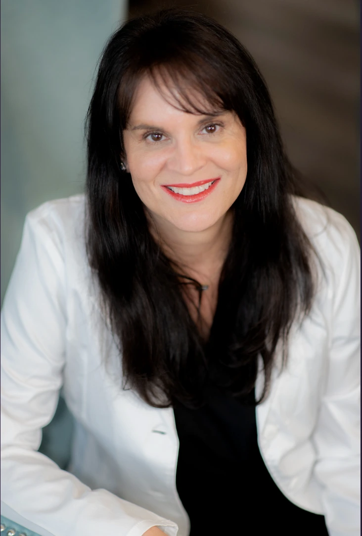 Dr. Smith smiling in a professional setting, representing Evolve HRT & Wellness in The Woodlands, TX