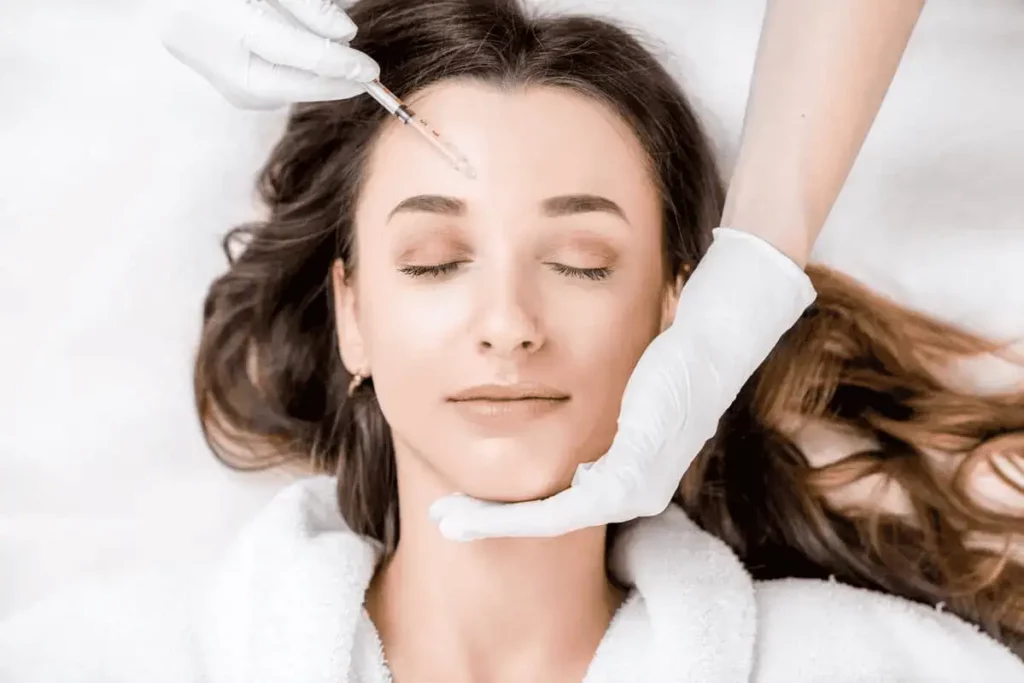 Landing Page 2 1 Close-up of a smiling woman with glowing skin, promoting aesthetic services at Evolve HRT & Wellness in The Woodlands, TX